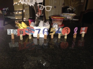 By searching online images of numbers, I found some cool 10-1 number designs, laminated them, cut them out, cut a slit in the top of a cork (we save our from our wine bottles...we drink a lot of wine lol), and slide the number in. Arrange on your table or bar as a centerpiece!