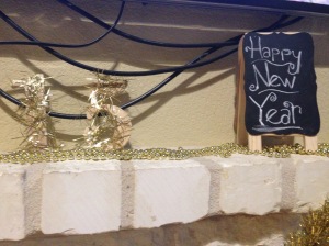 Pardon the wires! I used some gold beads for the top of the mantel, my wooden garland sparkly 15 numbers, and chalkboard gave this part of the house a little shout out. People congregate in the kitchen and dining area, so I left this area simple.